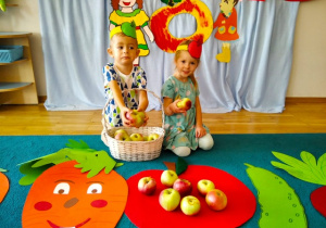 Wojtuś i Liwia odszukują wśród warzyw ukryte jabłko.