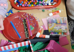 Dzieci wybierają materiały do wykonania masek karnawałowych.